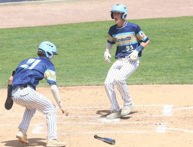 Marquette's Griffin Dobberstein scores a run as teammate Easton Dbernardi welcomes him home during the Class 1A semifinal game on Friday, May 31, 2024 at Dozer Park in Peoria.