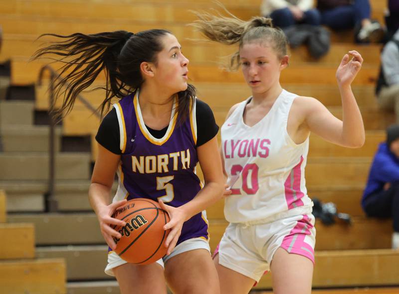 Downers Grove North’s Campbell Thulin (5) goes up against Lyons Township’s Avery Mezan (20) during the girls varsity basketball game on Tuesday, Jan. 16, 2024 in La Grange, IL.