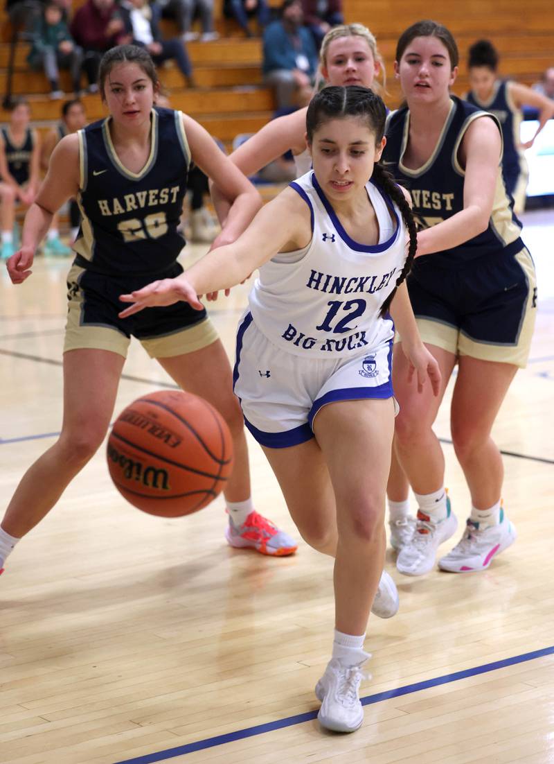 Hinckley-Big Rock’s Lilliana Martinez tries to save a ball from going out-of-bound in front of two Harvest Christian defenders Monday, Jan. 8, 2023, during their game at Hinckley-Big Rock High School.