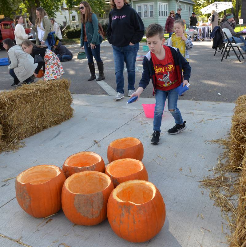 Luca Calandrella, 6, of Cherry Valley, tosses a bean bag at pumpkins at the Autumn on Parade Fun Zone on Saturday, Oct. 7, 2023. Games were one of the free activities for kids in the Fun Zone.