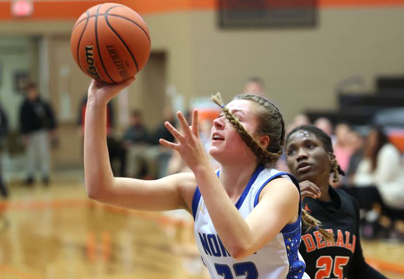 Wheaton North's Mira Spillane gets a shot up in front of DeKalb’s Kezaria Mitchell during their Class 4A regional game Monday, Feb 12, 2024, at DeKalb High School.