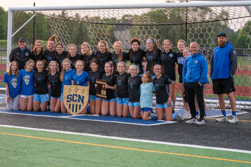 St. Charles North players and coaches pose for pictures after winning the Class 3A girls soccer regional final against Wheaton Warrenville South at St. Charles North High School on Friday, May 19, 2023.