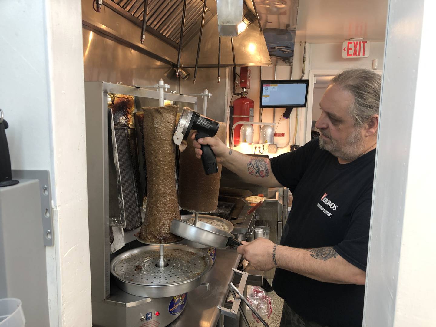 Pete Tzimpas shaves gyro meat in the kitchen at To Steki on Friday, May 10, 2024. The McHenry restaurant features Greek and American foods.