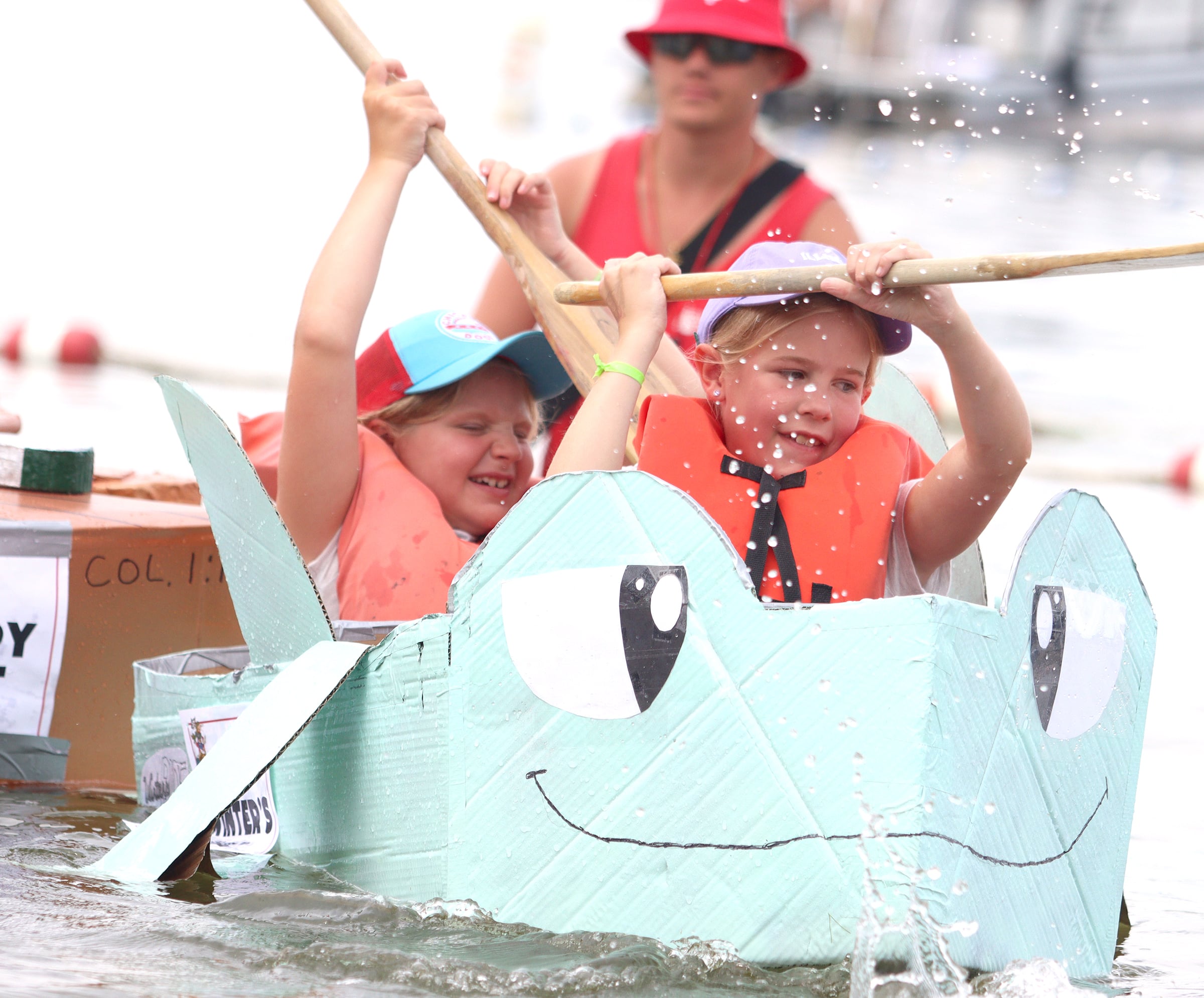 The Winter’s Ride team dashes for the finish during the Cardboard Regatta on Crystal Lake Saturday.