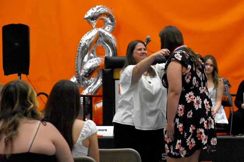 Megan Bennett, division chair for McHenry Community High School’s fine arts and world languages department, awards a medal for Commendation toward Biliteracy to Lynette Alsot during McHenry Community High School's Senior Awards Night in May.