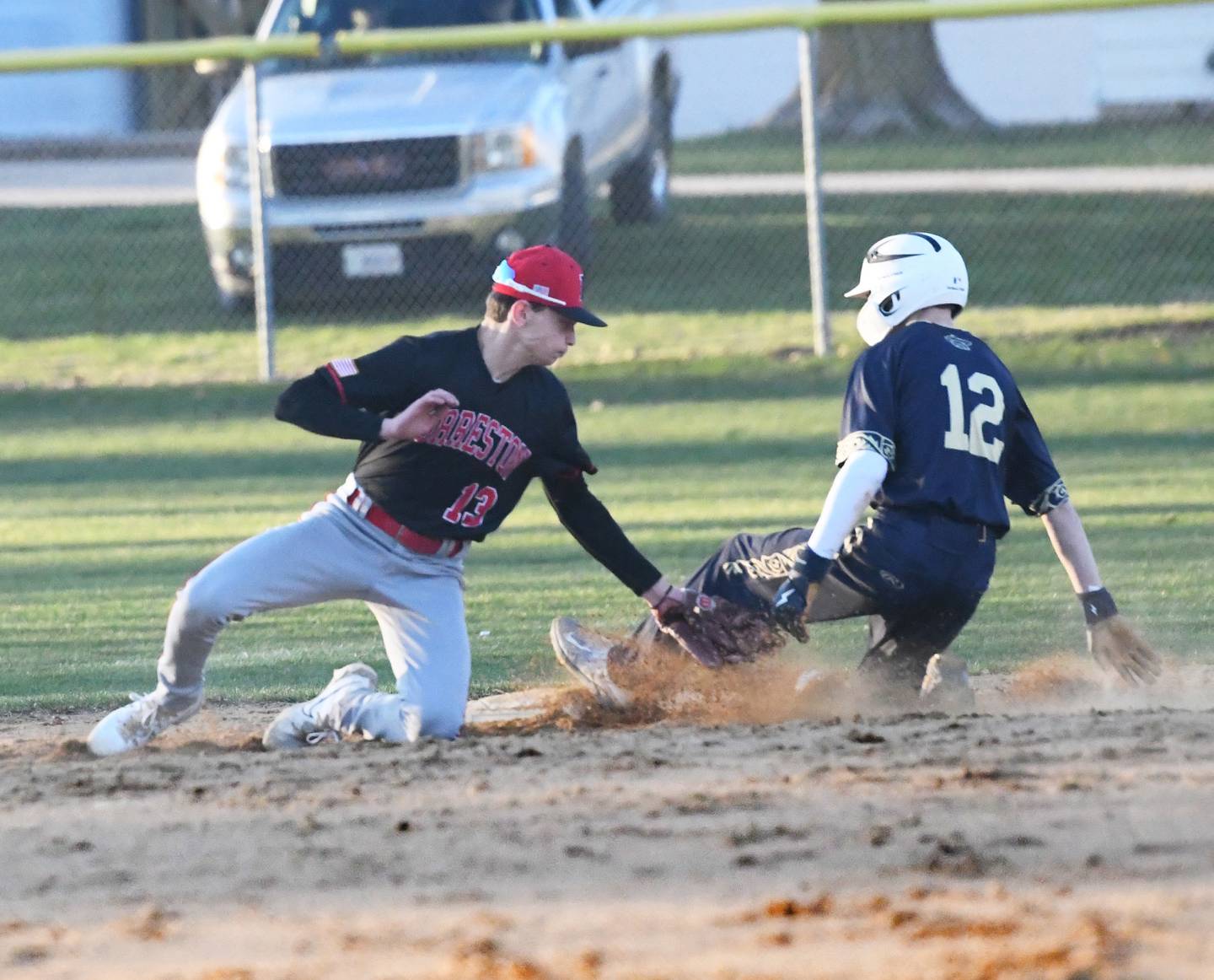 Polo's Billy Lowry slides safely into second base as Forreston's Kendall Erdmann lays down the tag during an April 6 game in Polo.