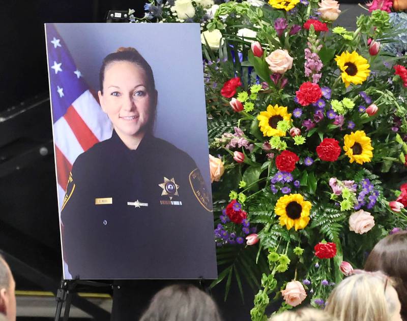 A photo of fallen DeKalb County Sheriff’s Deputy Christina Musil is displayed Thursday, April 4, 2024, during her visitation and funeral in the Convocation Center at Northern Illinois University. Musil, 35, was killed March 28 while on duty after a truck rear-ended her police vehicle in Waterman.