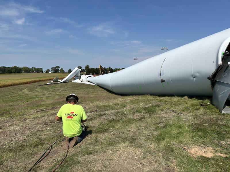 Zach Poulson of DW Zinser works on dismantling the wind turbine that stood near the Erie Middle School on Thursday, Sept. 5, 2024. Workers pulled down the 200' turbine on Sept. 4 and are now in the process of cutting it into pieces for removal.