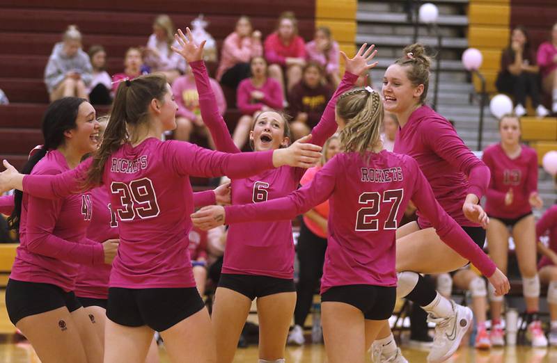 Richmond-Burton's Brianna Maldonado, (from left to right) Alex Hopp Maggie Uhwat, Lilly Mombower, Dani Hopp and Elissa Furlan celebrate defeating Woodstock North in a Kishwaukee River Conference volleyball match on Wednesday, Oct.11, 2023, to win the conference championship at Richmond-Burton Community High School.