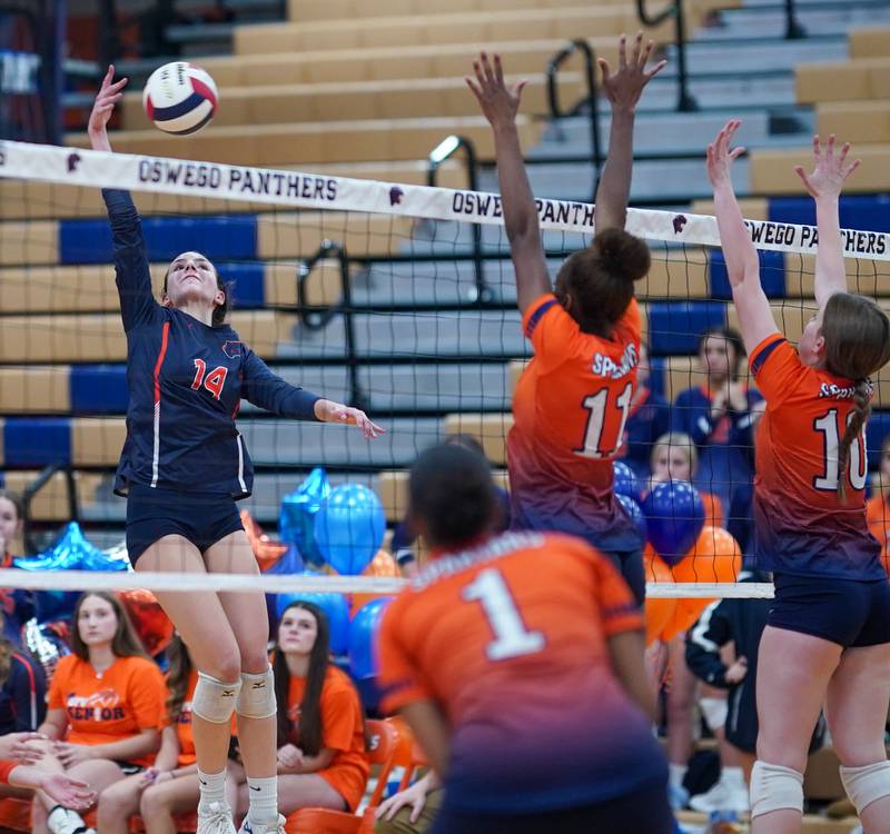 Oswego’s Mia Jurkovic (14) goes up for a kill against Romeoville during a volleyball game at Oswego High School on Tuesday, Oct. 17, 2023.