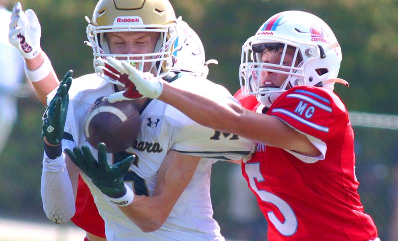 Marian Central’s Michael Schmid breaks up a pass intended for Bishop McNamara’s Richie Darr in varsity football action on Saturday, Sept. 14, 2024, at George Harding Field on the campus of Marian Central High School in Woodstock.