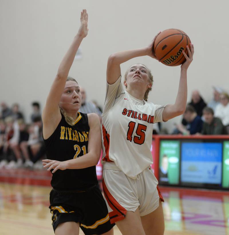 Stillman Valley's Taylor Davidson (15) shoots as Riverdale's Kayleigh Hungate (21) defends on Tuesday. Feb. 20, 2024 at the 2A Oregon Sectional held at the Blackhawk Center at Oregon High School. Davidson scored 31 points in the Cardinal's 57-34 win over the Rams.