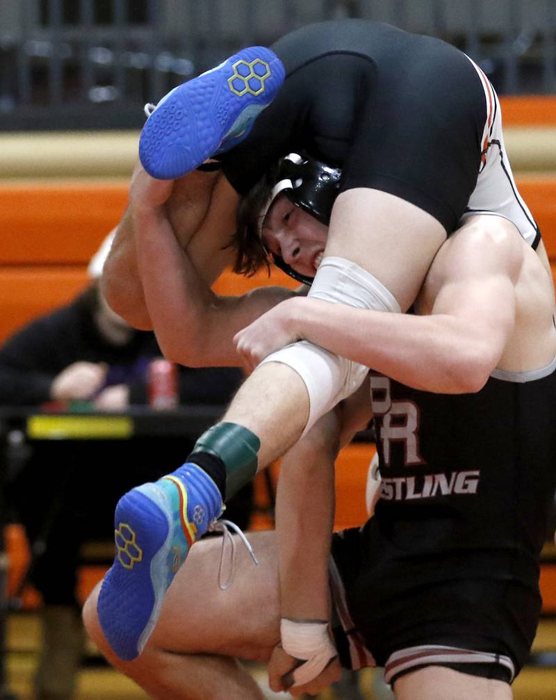 Prairie Ridge’s Milkey Meade tries to control  Kaneland’s Alex Gochis during the 126-pound championship match of a the IHSA 2A Crystal Lake Central Wrestling Regional on Saturday, Feb. 3, 2024, at Crystal Lake Central High School.