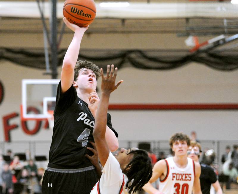 Oswego East's Braydon Murphy (4) shoots the ball over a Yorkville defender during a varsity basketball game at Yorkville High School on Friday, Feb. 9, 2024.