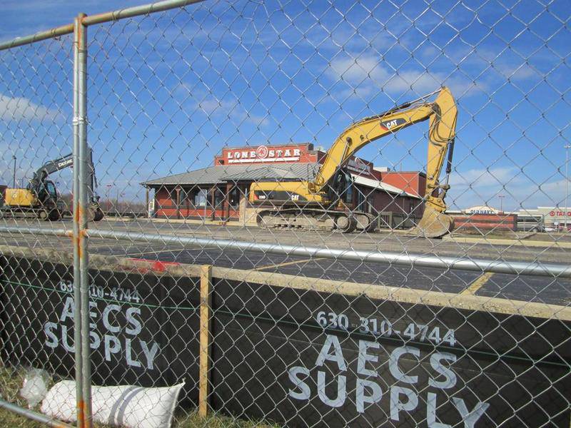 Excavation equipment stands in front of the vacant Lone Star Restaurant, which will be demolished to make room for a Chick-fil-A in Joliet.