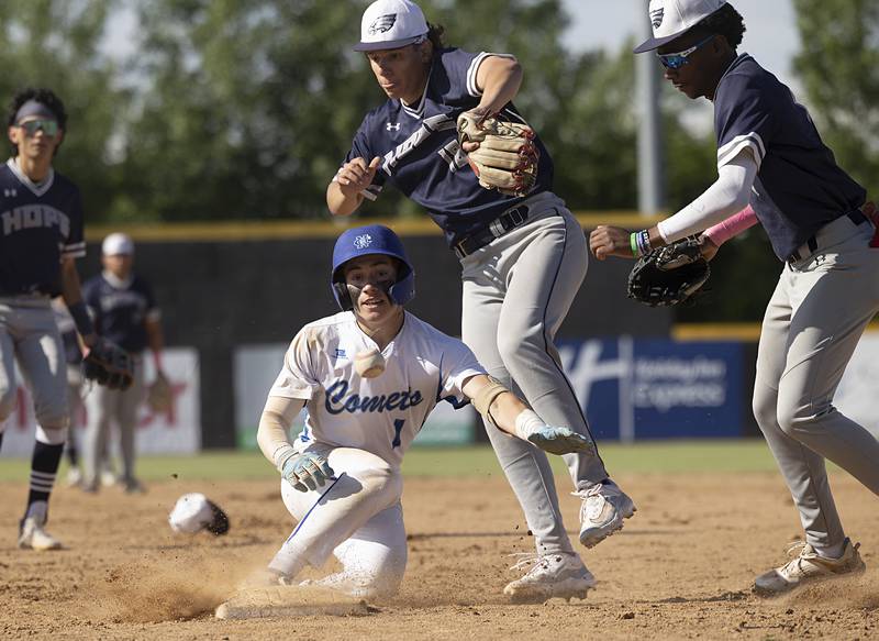 The ball gets away as Newman’s Garet Matznick scrambles back to first safely after getting into a run down against Chicago Hope Monday, May 27, 2024 during the Class 2A super-sectional in Rockford.