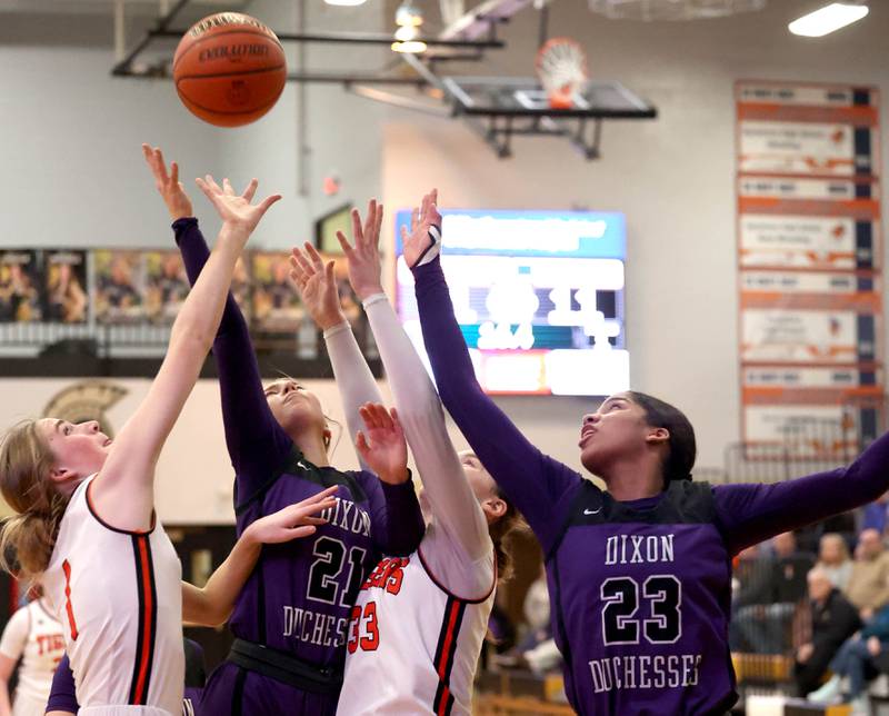 Dixon and Crystal Lake Central players go after a rebound during their Class 3A sectional semifinal Tuesday, Feb. 20, 2024, at Sycamore High School.