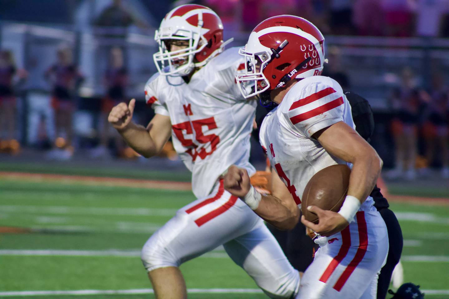 Morrison's Logan Baker (4) rushes upfield with Jason Hall (55) moving in to provide blocking space on Friday in Kewanee. Kewanee won 16-14.