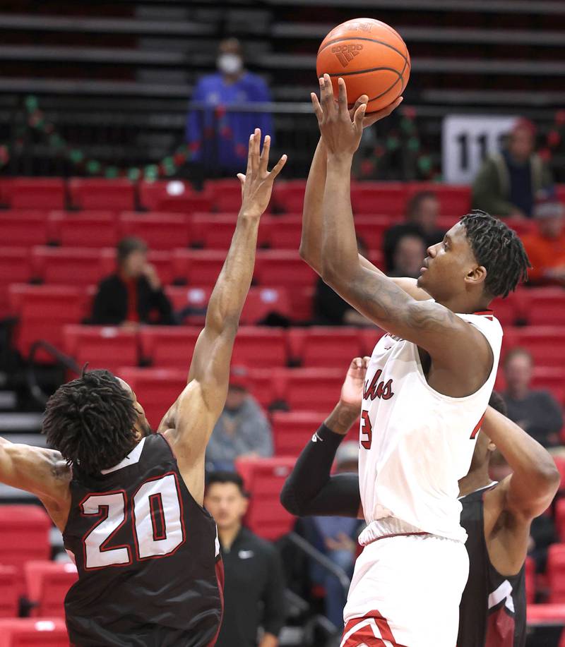 Northern Illinois' Xavier Amos shoots over Calumet’s Devan Nichols during their game Monday, Dec. 18, 2023, at the Convocation Center at NIU in DeKalb.