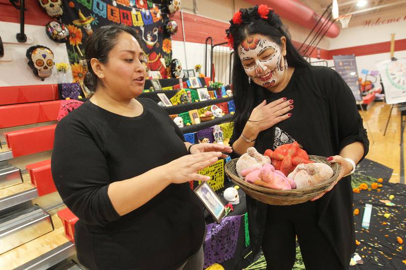 Diana Nava, of Round Lake talks with Yesenia Flory, of Fox Lake about pan de muerto during the Dia de los Muertos, Day of the Dead event at Stanton Middle School on November 4th in Fox Lake. The event was sponsored by the Bilingual Parents Advisory Committee (BPAC) from School Districts 114,124 and 37.
Photo by Candace H. Johnson for Shaw Local News Network