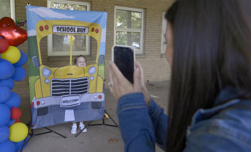 Brittany Lewis takes a photo of her son Hudson at a schools prop on the first day of school Wednesday, Aug. 21, 2024, at McKinley School in Ottawa.