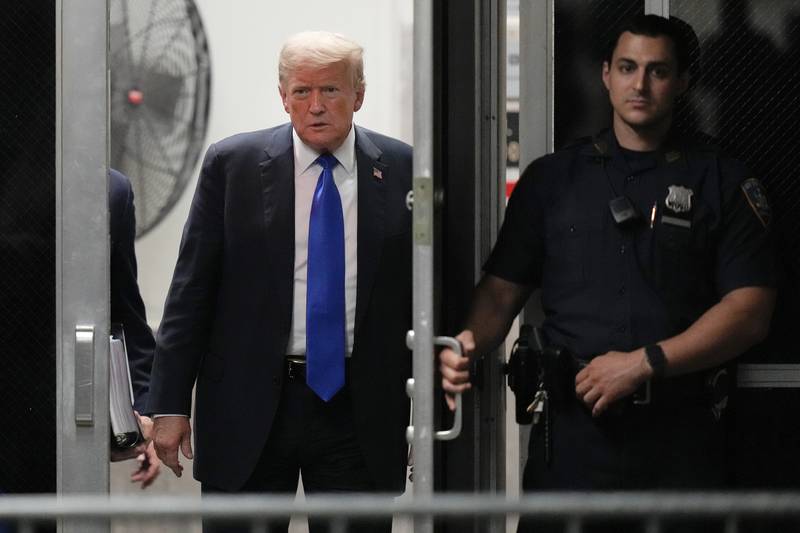 FILE - Former President Donald Trump returns to the courtroom at Manhattan Criminal Court, May 30, 2024, in New York. Americans are about evenly split on whether Trump should face prison time for his recent felony conviction on hush money charges, according to a new poll from the AP-NORC Center for Public Affairs Research conducted June 20-24. (AP Photo/Seth Wenig, Pool)