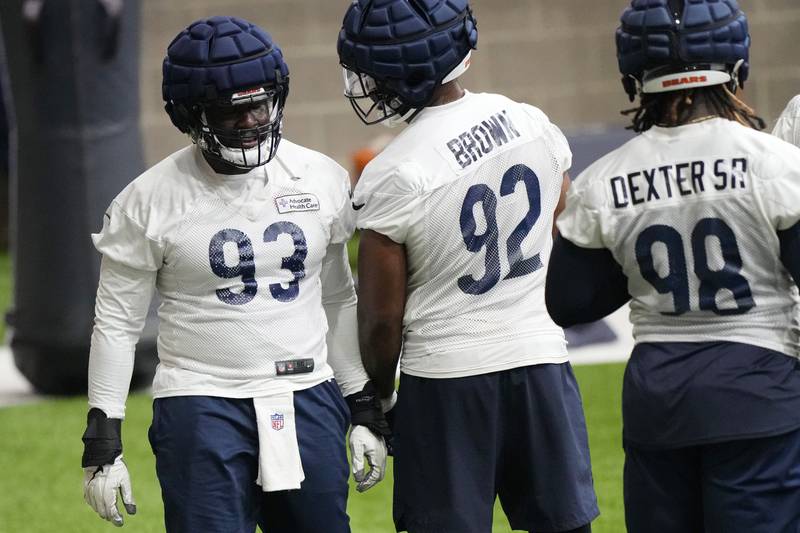 Chicago Bears defensive lineman Justin Jones (left) talks with defensive lineman Andrew Brown and defensive lineman Gervon Dexter during practice, , Tuesday, June 13, 2023, in Lake Forest.