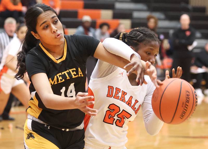 Metea Valley's Sreehi Duggirala and DeKalb’s Kezaria Mitchell go after a loose ball during their game Friday, Jan. 19, 2024, at DeKalb High School.