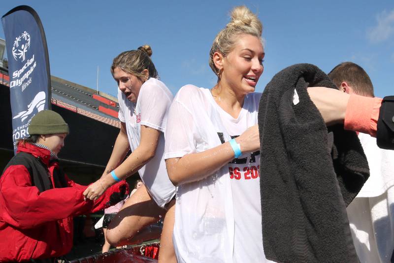 Members of the Alpha Sigma Alpha sorority emerge from the water on a cold and windy Saturday, Feb 17, 2024, during the Huskie Stadium Polar Plunge at Northern Illinois University in DeKalb. The Polar Plunge is the signature fundraiser for Special Olympics Illinois.