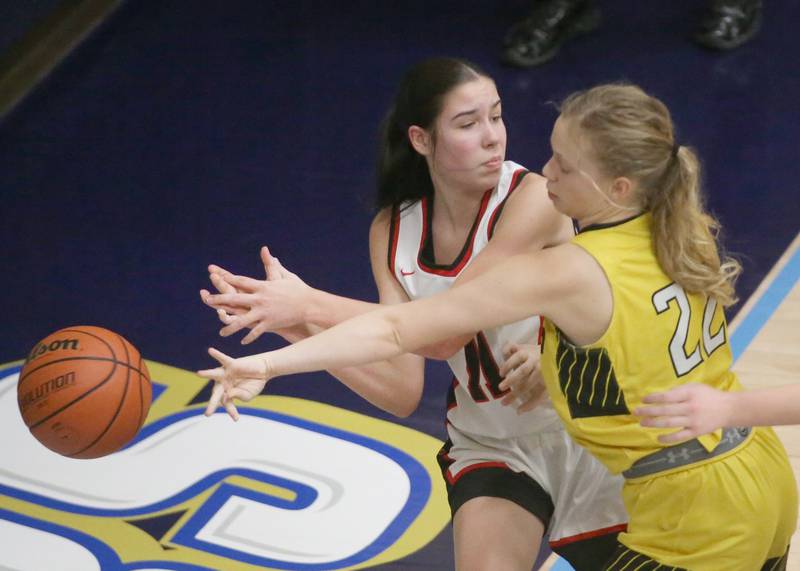 Amboy's Tyrah Vaessen looses control of the ball as Putnam County's Kacie Coleman defends during the Class 1A Regional semifinal game on Monday, Feb. 12, 2024 at Marquette High School.