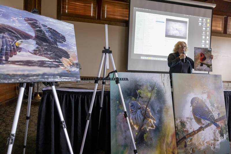 Commercial photographer and graphic design artist Sandra Rust presents her mixed media photo art to a crowd of people at Starved Rock Lodge on January 28, 2024.