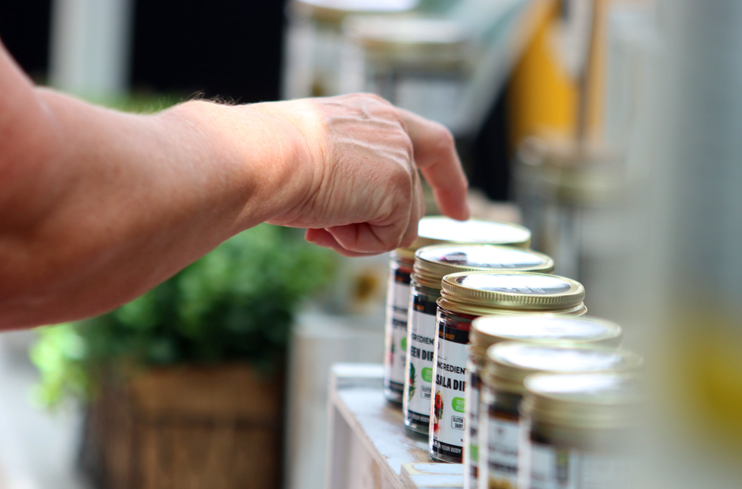 Plant-based dips and avocado oils are sold as part of The Dole Farmers Market in Crystal Lake Sunday.