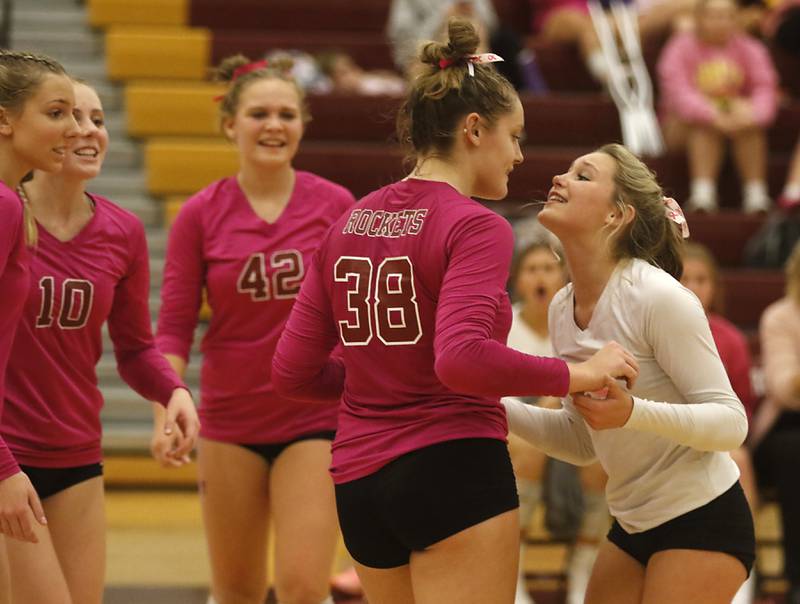 Richmond-Burton's Lanee Cooley (right) celebrates a point with Elissa Furlan during a Kishwaukee River Conference volleyball match against Woodstock North  Wednesday, Oct.11, 2023, at Richmond-Burton Community High School.