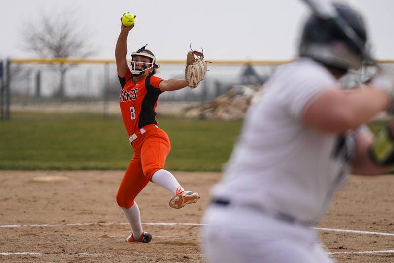 St. Charles East's Grace Hautzinger (8) delivers a pitch against Oswego East during a March softball game at Oswego East High School.