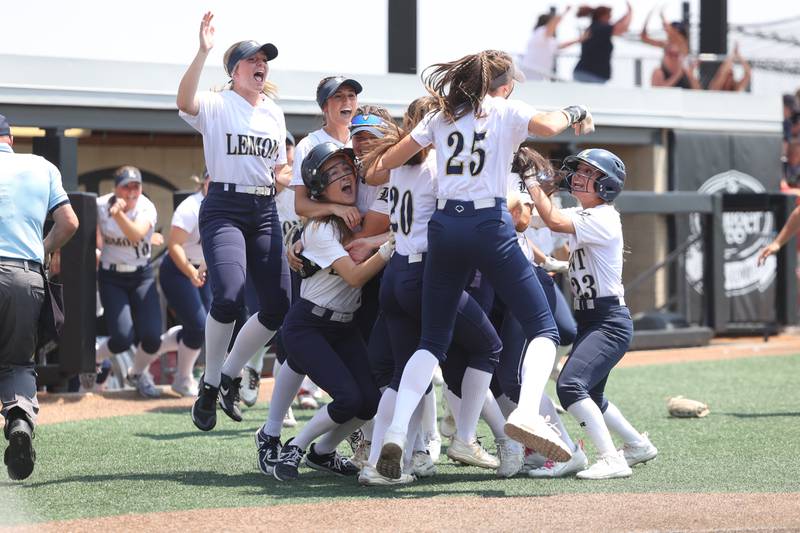 Lemont players mob Addison McGrath after scoring to win the game 1-0 against Antioch in the Class 3A state championship game on Saturday, June 10, 2023 in Peoria.