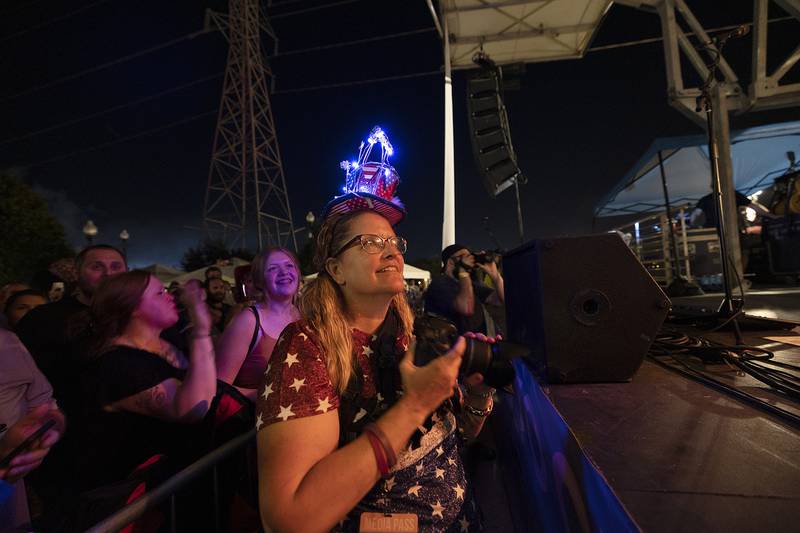 Petunia Fest photographer Jennifer Lubbs dons a patriotic hat while documenting Everclear Monday, July 3, 2023 in Dixon.