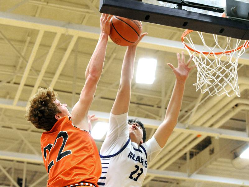 Plano's Isaiah Martinez (23) blocks Sandwich's Dom Rome's shot during a varsity basketball game at Plano High School on Tuesday, Dec. 5, 2023.