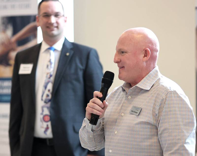 Brian Granger, from Communities By Granger, speaks after accepting the Community Diamond Award as Sycamore Chamber of Commerce Board President Robert Heck looks on during the annual meeting of the chamber Thursday, April 7, 2022, at St. Mary Memorial Hall in Sycamore.