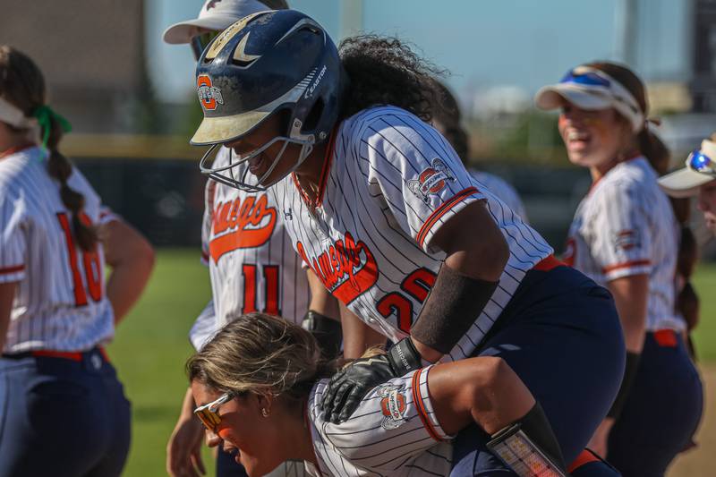 Oswego's Jaelynn Anthony (20) jumps on one of her teammates for a ride after hitting a homerun during Class 4A Plainfield North Sectional semifinal softball game between Wheaton-Warrenville South at Oswego. May 29th, 2024.