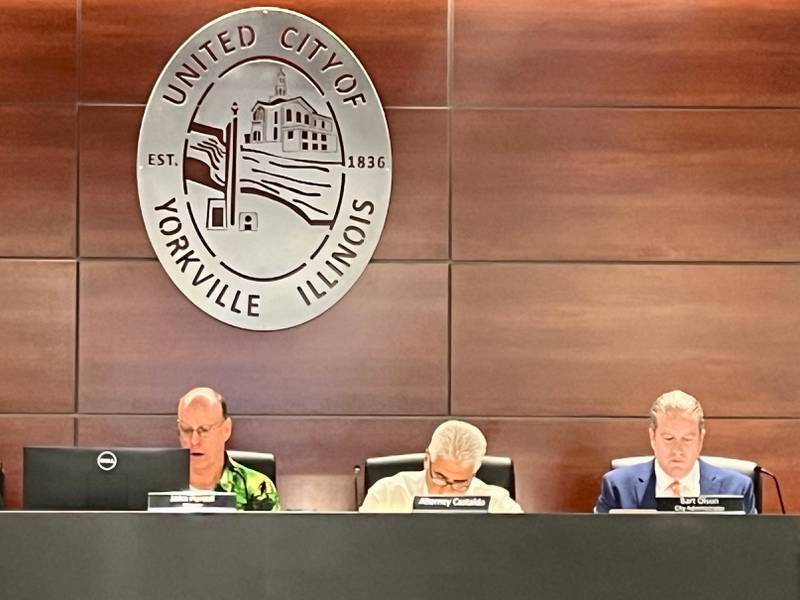 Yorkville Mayor John Purcell (left) and City Administrator Bart Olson (far right) address the City Council at the Aug. 27 meeting.