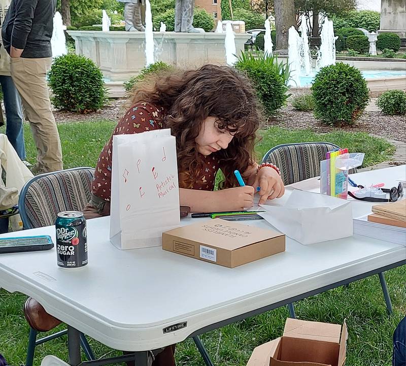 Corinne Francis makes memorials Friday, June 7, 2024, during A Night of Remembrance at Washington Square in Ottawa.