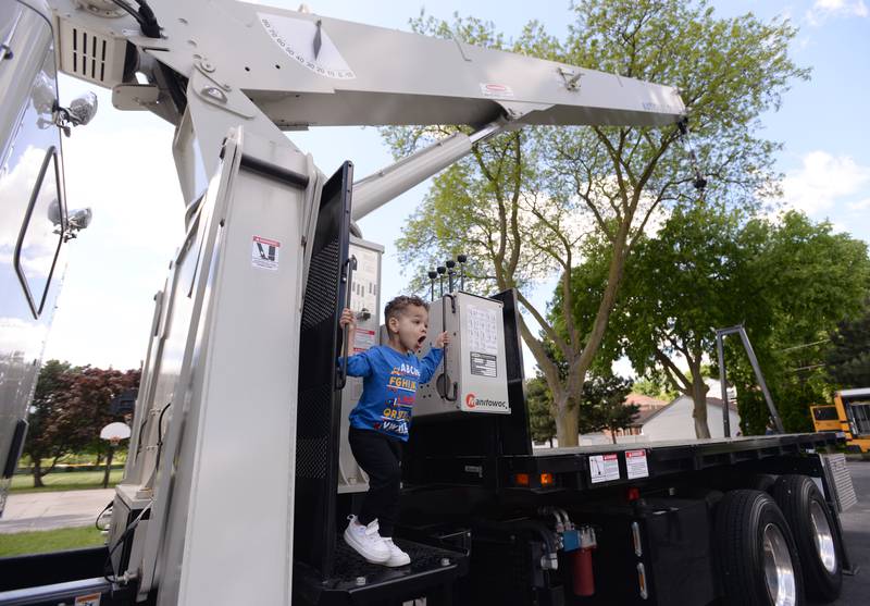 Children including Manny Abad of Lagrange Park enjoy being on a large crane while attending the La Grange Park District's Touch A Truck event held at Sedgwick Park Saturday May 11, 2024.