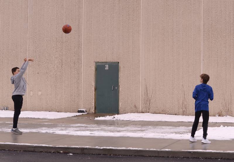 (left) Beck and Reed Holstad of Lagrange Park pass the ball outside the LaGrange Park District during Youth Basketball held Saturday, Jan 6, 2024.