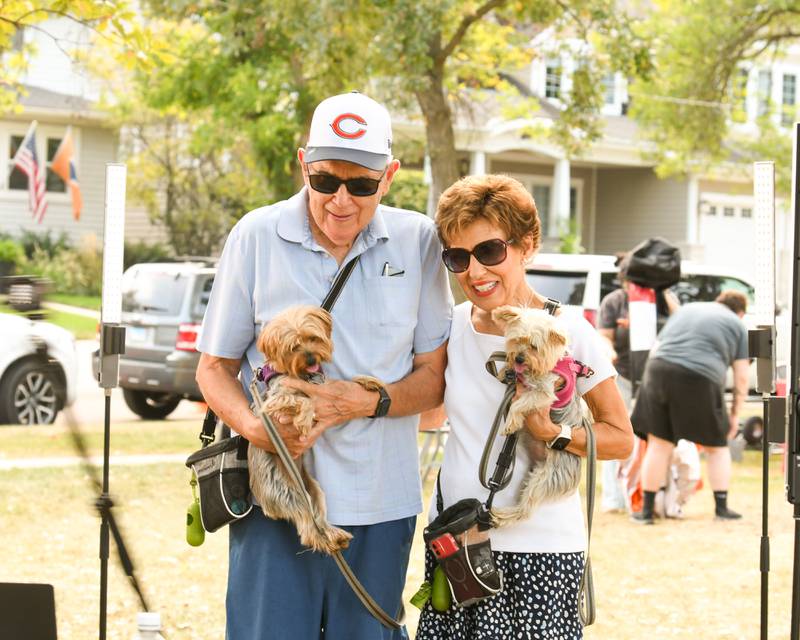 Karen Mudra holds Milly,3, while her husband Emil Mudra, of Downers Grove, holds Molly, 3, Yorkshire terriers for a 360 degree photo during dog Daze on Saturday Sept. 14, 2024, at Fishel Park in Downers Grove.