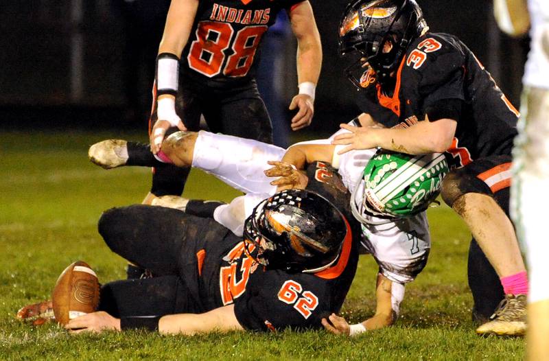 Ridgewood quarterback Jaden Rodriguez (7) gets sack by Sandwich defenders Tate Frieders (62) and Jimmy Ramey (33) to force a 4th-down, during a varsity football game at Sandwich High School on Friday, Oct. 27, 2023.