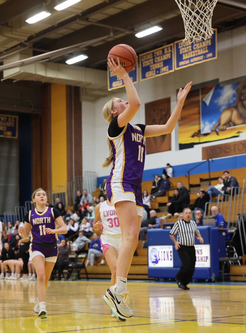 Downers Grove North’s Abby Gross (11) goes in for a layup against Lyons Township during the girls varsity basketball game on Tuesday, Jan. 16, 2024 in La Grange, IL.