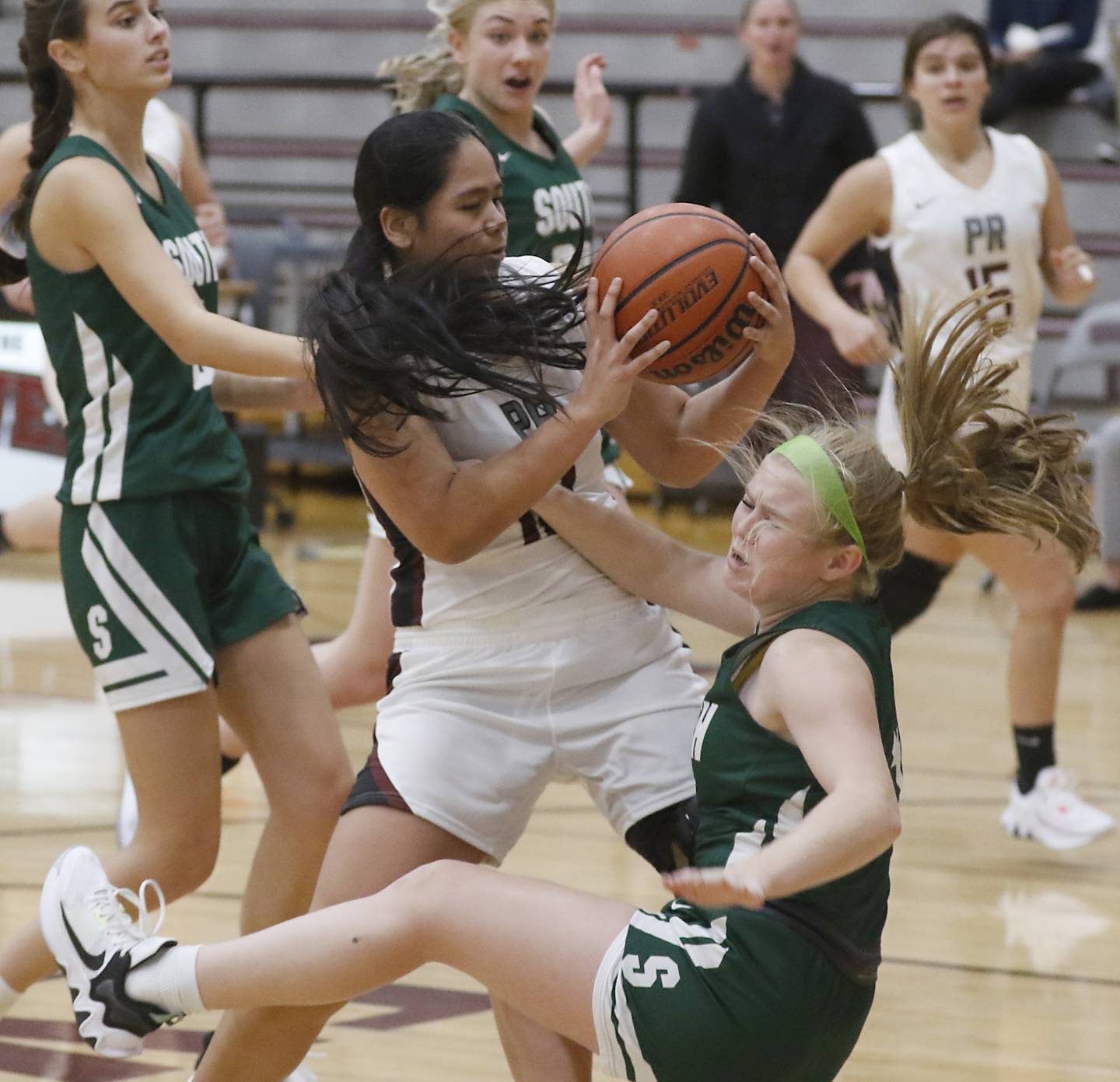 Prairie Ridge's Kate Pactol knocks Crystal Lake South's Addison Alexander to the ground as she drives the lane during a Fox Valley Conference girls basketball game Tuesday, Dec. 6, 2022, between Prairie Ridge and Crystal Lake South at Prairie Ridge High School. Pactol was called for charging on the play.