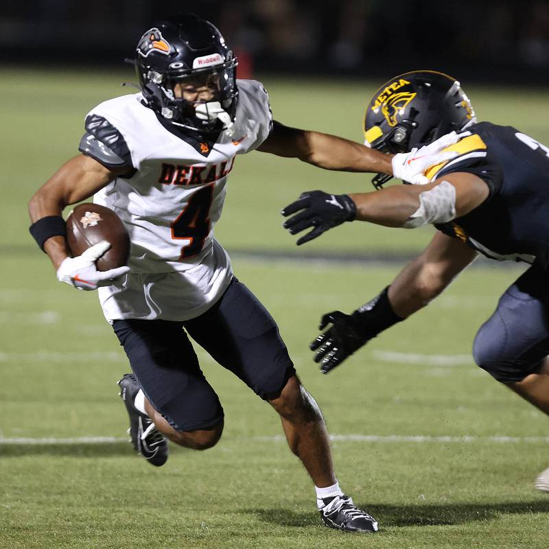 DeKalb's Xavier Dandridge tries to break the tackle of Metea Valley's Hani Omar during their game Friday, Sept 15, 2023, at Metea Valley High School in Aurora.