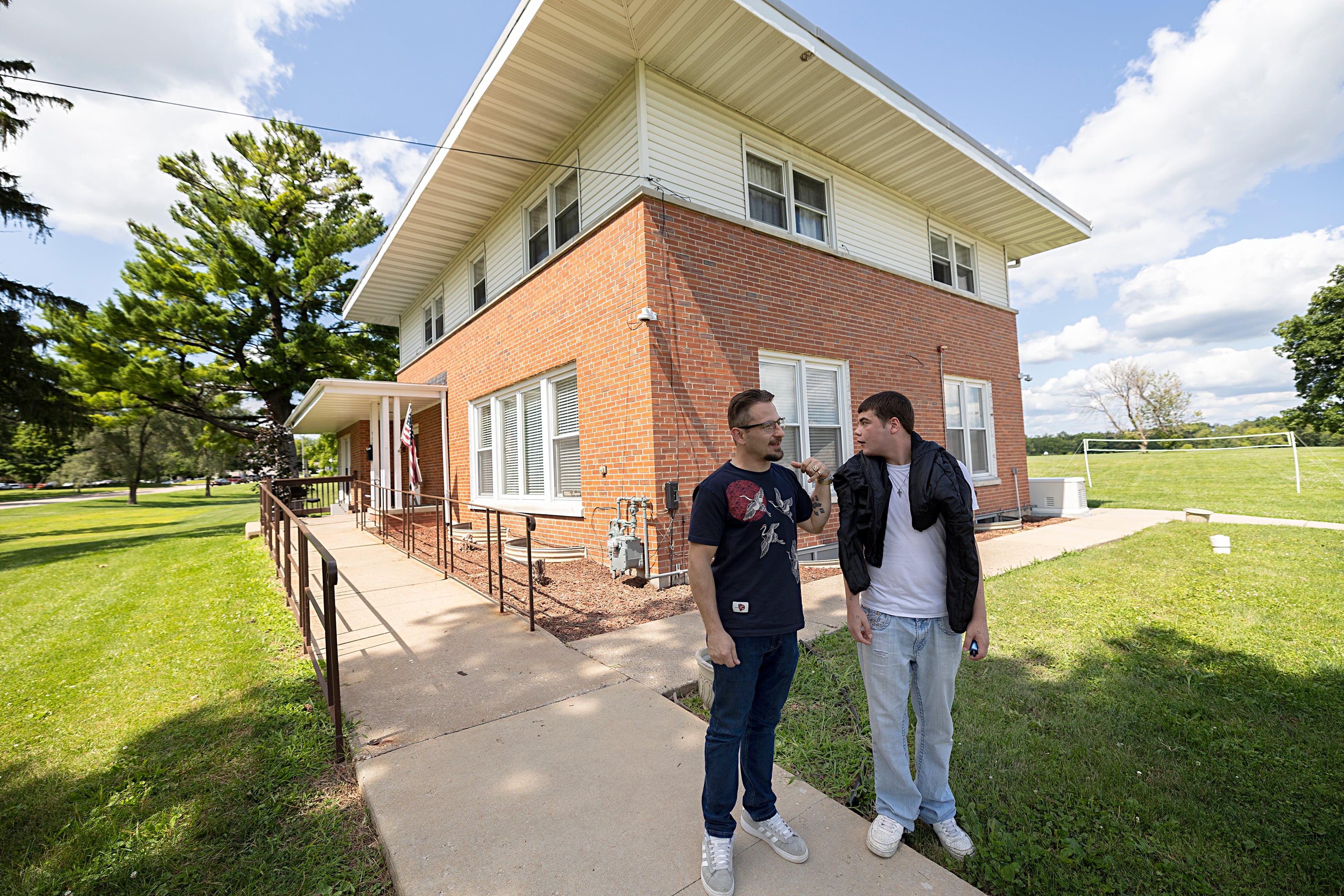 Nikola Balaban (left), 31, and Michael Johnson, 20, talk outside of the Sinnissippi Centers’ Recovery Home on Thursday, July 18, 2024.