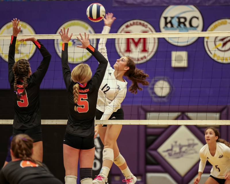 Plano's Emily Santolin (12) spikes the ball during volleyball match between Sandwich at Plano.  August 21, 2023.